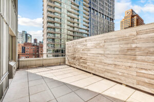 Unit Patio, wood fencing, metal railing, view of city