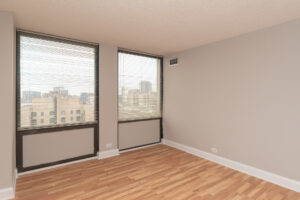 Unit Bedroom, 2 large windows, wood floors, view of downtown chicago.