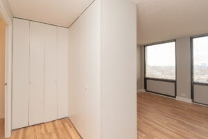 Unit hallway, accordion style closet space. wood floors.