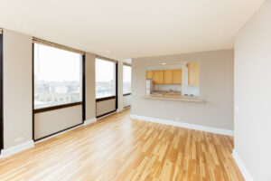 Unit Living Room, Wood Floors, Large Windows, Breakfast bar attached to kitchen.
