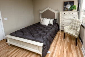 Unit Bedroom, Wood Floors, Large Rustic Dresser, Queen size bed.