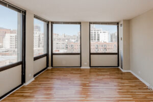 Unit Living room, wood floors, 4 large windows looking at downtown chicago