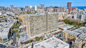 Aerial Exterior of lincoln park plaza and surrounding businesses, photo taken on a sunny day.